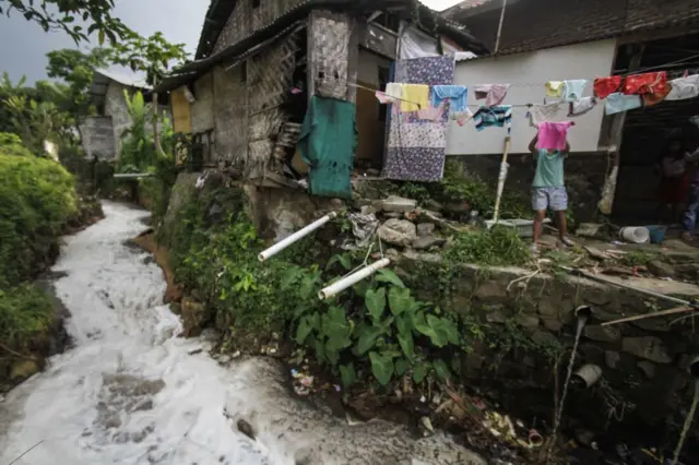 Limbah tekstil mengalir di Desa Sukamaju, Majalaya, Bandung, Jawa Barat, pada Maret 2018.