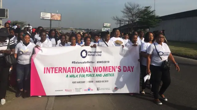 Women and girls wey dey waka for di International Women's Day match