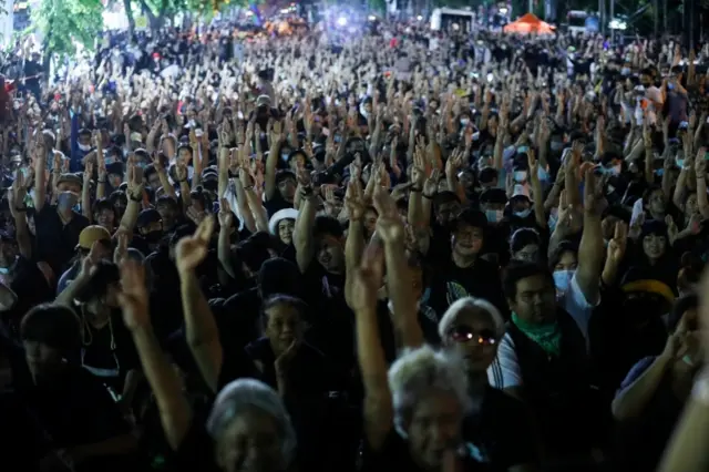 Pro-democracy demonstrators flash the three-fingers salute as they gather during a Thai anti-government mass protest, on the 47th anniversary of the 1973 student uprising, in Bangkok, Thailand October 14, 2020