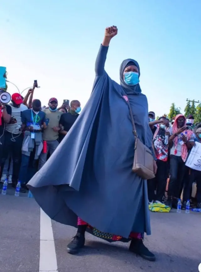 End SARS protester Aisha Yesufu raise hand for air
