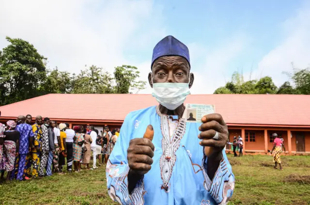 Old man with face mask wey just vote