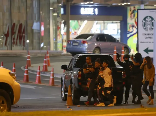 The people trapped within the incident are rescued by the officials,, after a suspected Thai soldier opened fire in a rampage at the Terminal 21
