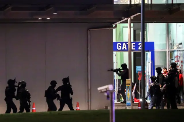 Thai security forces enter a shopping mall chasing the hidden shooter after a mass shooting in front of the Terminal 21,