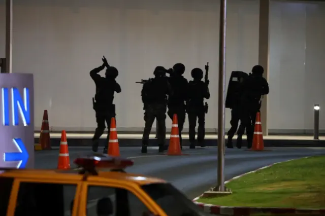 Thailand security forces enter in a shopping mall as they chase a shooter hidden in after a mass shooting in front of the Terminal 21