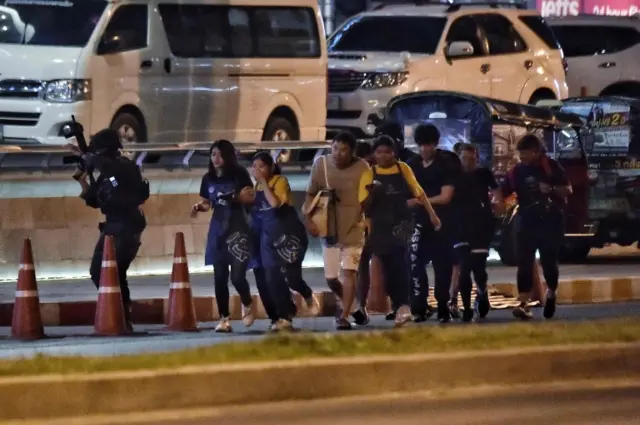 People run together as they are rescued by Thai commandos from Terminal 21 shopping mall,