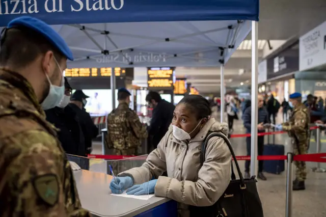 People wear face masks are checked by the Italian Army and Italian Police at the Termini Central