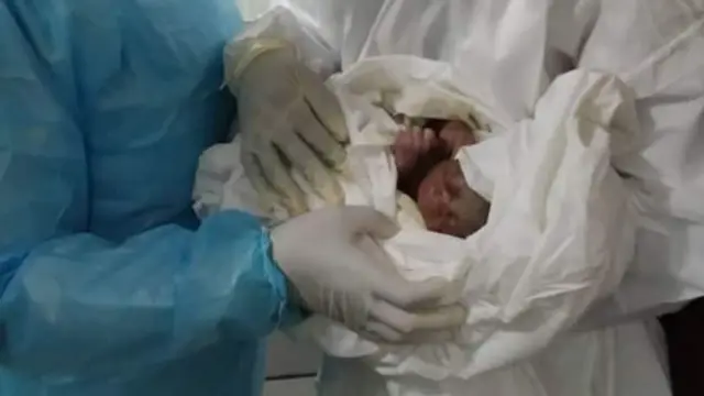 Dr. Yaneu Ngaha and Dr. Kemme Marilene with first baby from Covid-19 mother