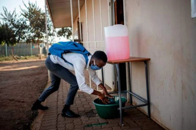 School boy wey dey wash hand