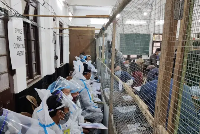 Officials in PPE kits