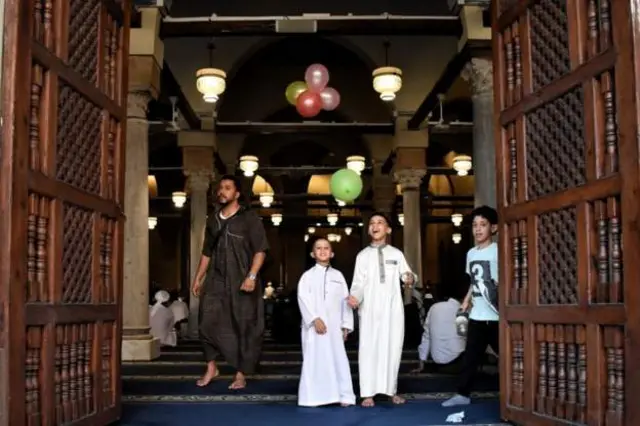 Children had fun with balloons at morning prayers at al-Azhar mosque in Cairo, Egypt