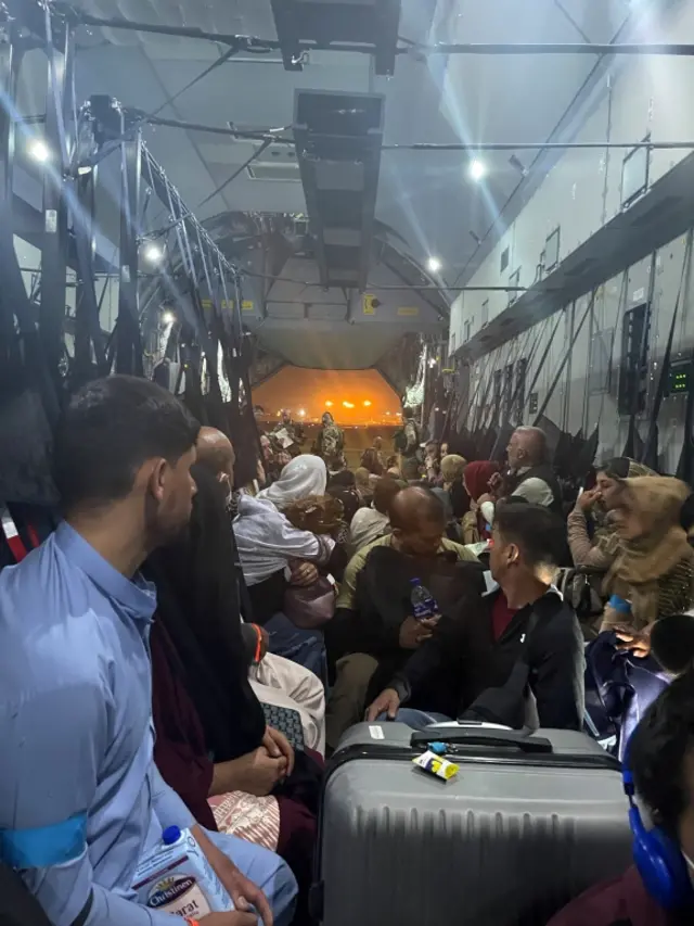 An amateur picture obtained by Reuters shows evacuees from Afghanistan inside an aircraft of the German Air Force Luftwaffe in Kabul, Afghanistan, August 18, 2021. Picture taken August 18, 2021. Handout via