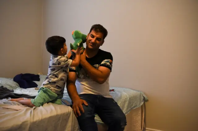 Afghan Abdul Aman Sediqi, a U.S. Special Immigrant Visa (SIV) recipient, plays with his son Elyan, 3, after he and his family speak about their evacuation from Afghanistan during an interview with Reuters in Houston, Texas, U.S., August 26, 2021. REUTERS/Callaghan O"Hare