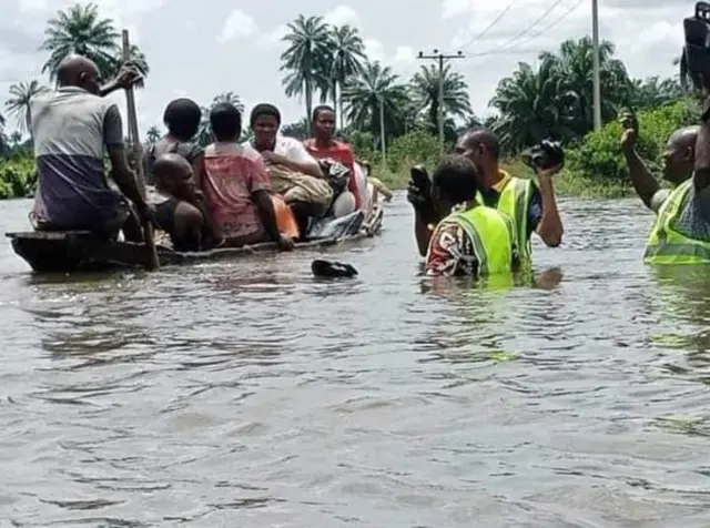 Pipo inside canoe ontop flood water