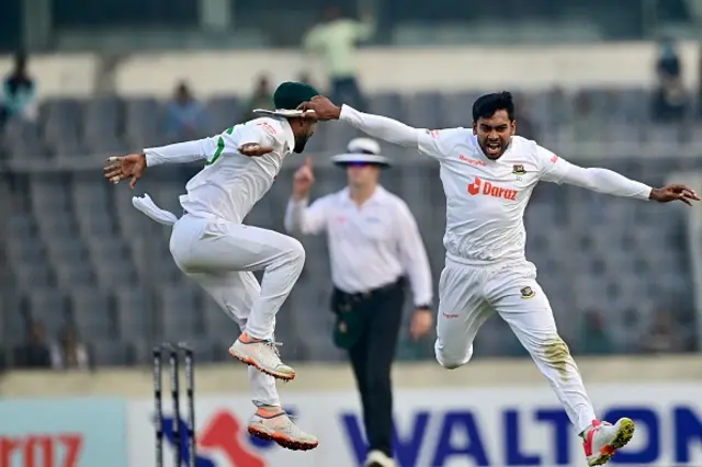 Bangladeshs Mehidy Hasan Miraz (R) celebrates after the dismissal of Indias Virat Kohli