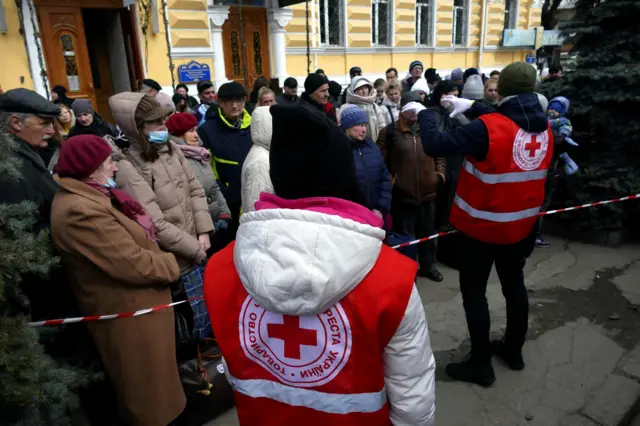 Volunteers from the Ukrainian Red Cross Society speak to people before their evacuation abroad, amid Russia"s invasion
