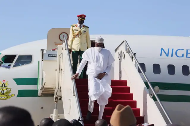 Foto of Nigeria President Muhammadu Buhari dey come down from plane