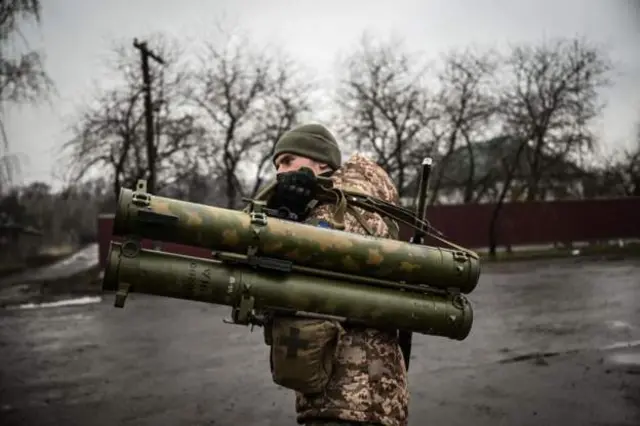 Ukraine soldier carry weapon