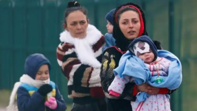 Ukrainian refugees cross into Poland at the border village of Medyka, Poland
