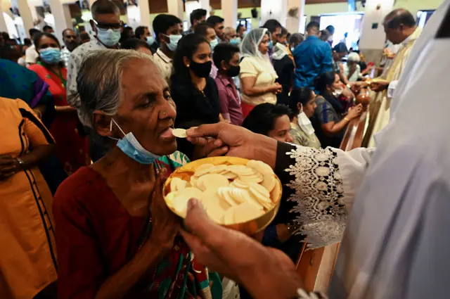 Wani Limamin Coci na bayar da sadaka mai tsarki ga mabiya addinin Kirista a ranar addu’o’in Easter a cocin St. Anthonys da ke Colombo Sri Lanka