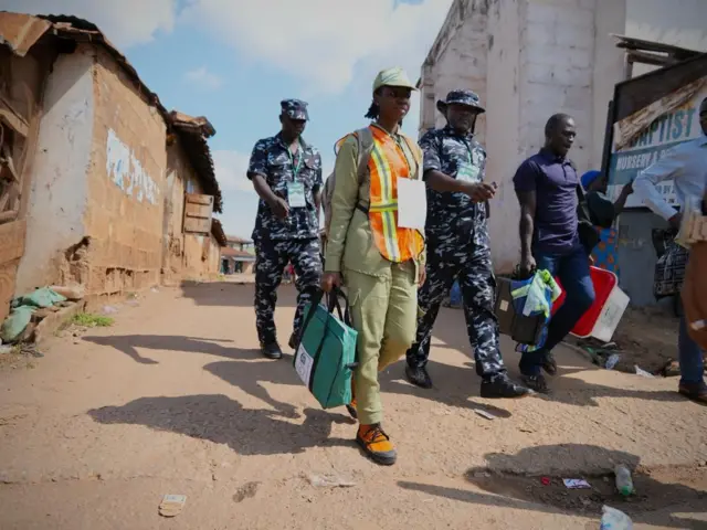 Inec adhoc staff escorted by security afta vote sorting and counting