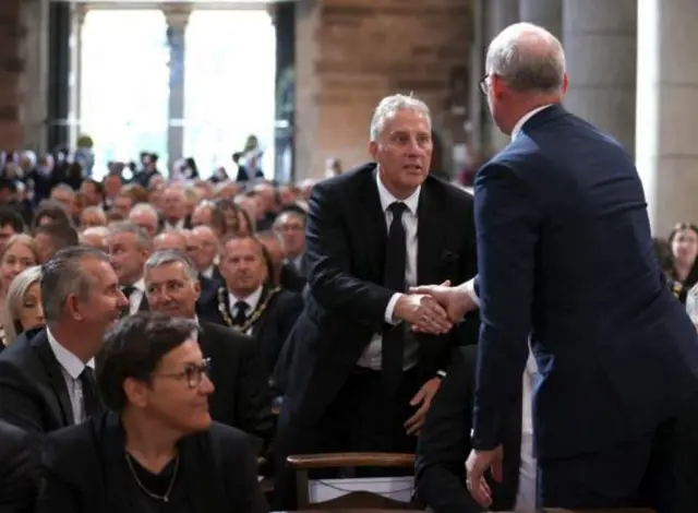 Ian Paisley shakes hands with Irish foreign affairs minister Simon Coveney