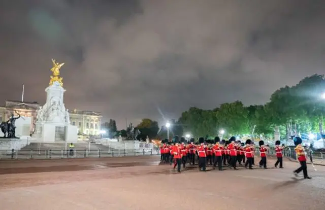 Soldiers march outside Buckingham Palace as part of rehearsals for the procession of Queen Elizabeth II's coffin