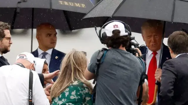 Mr Trump spoke to reporters at Reagan airport standing near his aide Walt Nauta (left), his co-defendant in a separate case