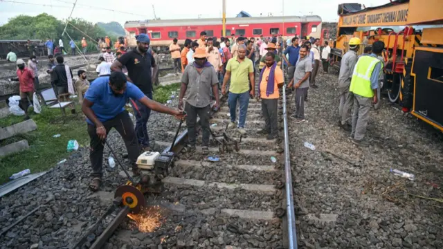 रेलवे लाइन को ठीक करने में जुटे कर्मी