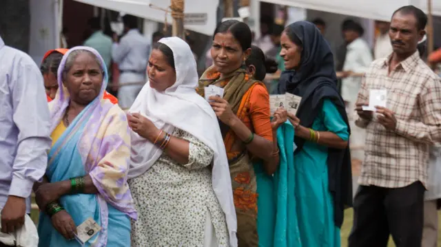 मतदान केंद्र पर लाइन में लगे मतदाता