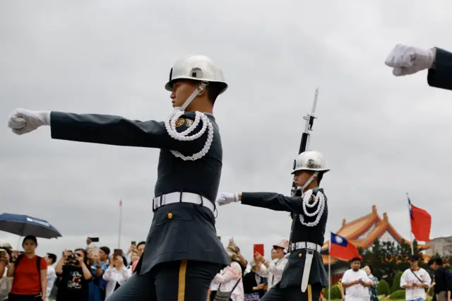 People observe the changing of honor guards in front of Chiang Kai-shek memorial hall at the Liberty square in Taipei, Taiwan, 22 October 2024.