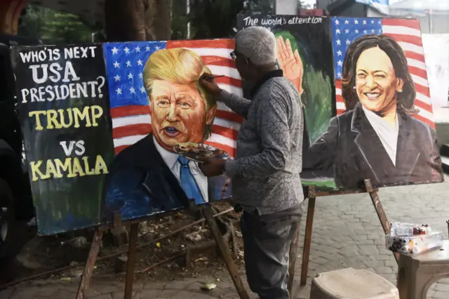 An Indian art school teacher paints an image of Democrat Kamala Harris and Republican Donald Trump