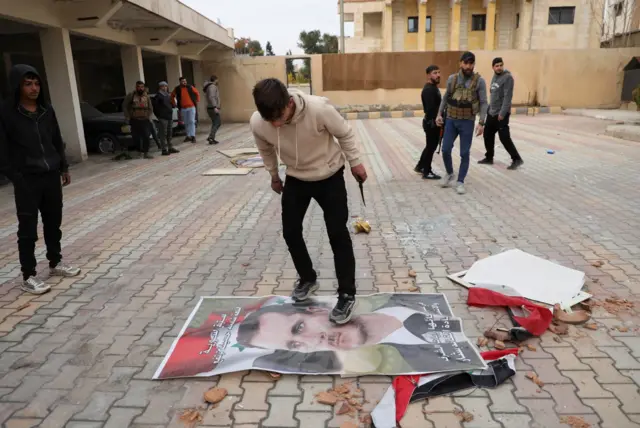 شخص يدوس على صورة الرئيس بشار الأسد، بعد أن استولت المعارضة على العاصمة وأطاحوا بالرئيس، في القامشلي، سوريا، 8 ديسمبر 2024.