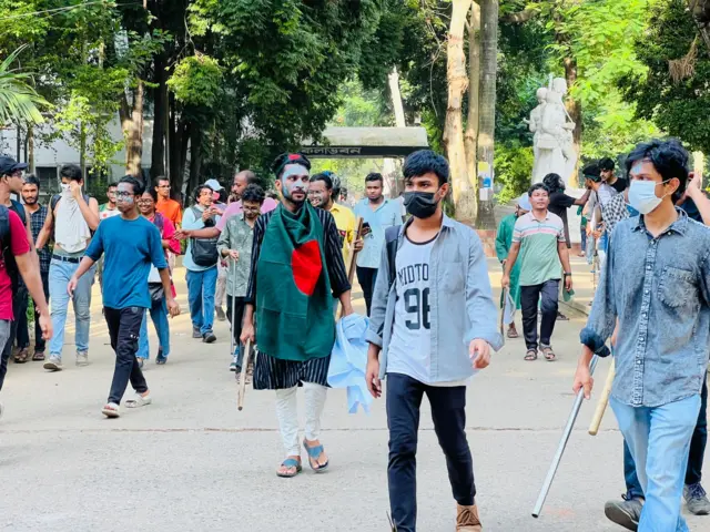 লাঠি হাতে শিক্ষার্থীরা