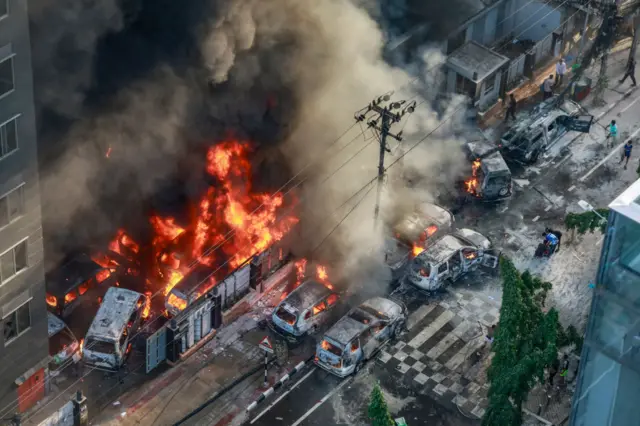 Smoke rises from the burning vehicles