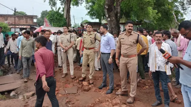 दीवार गिरने के बाद मौके पर मौजूद पुलिसकर्मी