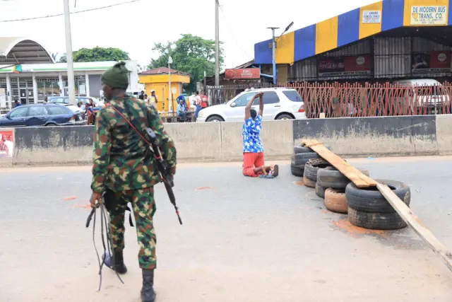 One armed security man and one lady kneel down