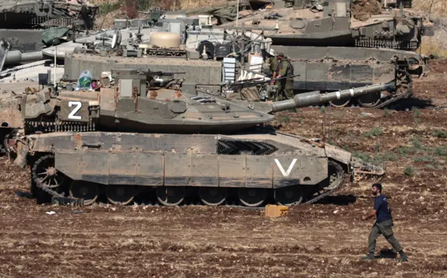 جنود إسرائيليون يقفون على دبابات عند نقطة تجمع في شمال إسرائيل، 28 سبتمبر 2024