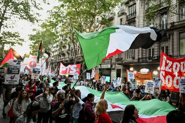 متظاهرون يحملون علماً فلسطينياً ضخماً خلال مظاهرة تضامناً مع أسطول الصمود العالمي  بعاصمة الأرجنتين، بوينس آيرس في 1 أكتوبر/تشرين الأول 2025.