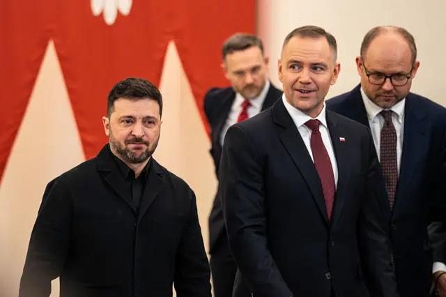 Karol Nawrocki, Poland's president, right, and Volodymyr Zelenskiy, Ukraine's president, arrive at a news conference at the Presidential Palace in Warsaw, Poland, on Friday, Dec. 19, 2025.