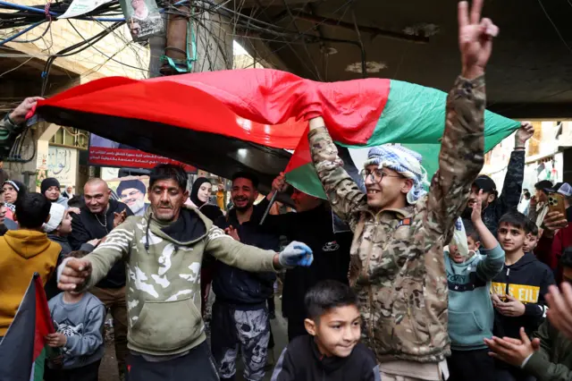 فلسطينيون يحتفلون بوقف إطلاق النار بين حماس وإسرائيل، في مخيم برج البراجنة للاجئين في بيروت، لبنان