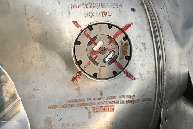 A part of an aircraft is seen on the ground in Wuyan near Indian-administered Kashmir's main city of Srinagar on May 7, 2025.