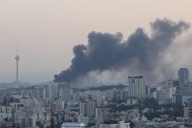 Smoke rises following an Israeli attack on the IRIB building, the country's state broadcaster, in Tehran