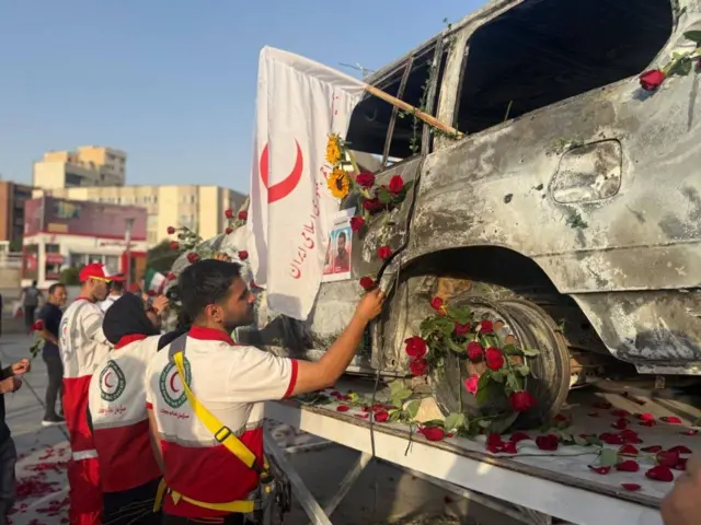 Iranian Red Crescent Society (IRSC) decorate destroyed vehicle, Tehran