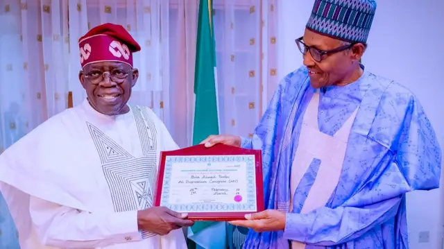 Tinubu receiving certificate from Buhari
