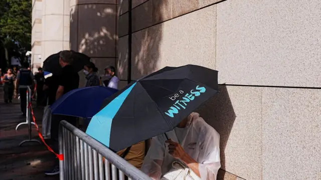 People queue to enter the West Kowloon Magistrates' Courts building for the closing submissions in the national security collusion trial of Jimmy Lai, founder of the now-defunct pro-democracy newspaper Apple Daily, in Hong Kong, China, August 15, 2025. REUTERS