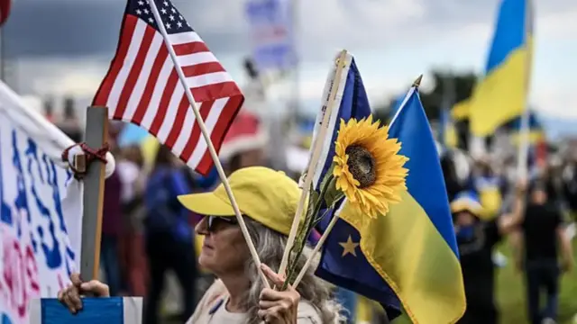 люди с американской и украинской символикой на уличной акции на Аляске
