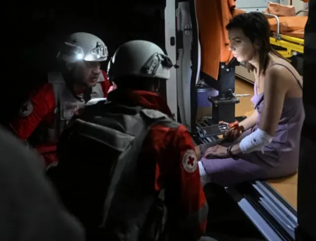 Ndị ọrụ ahụike nọ na-agwọ nwaanyị merụrụ ahụ n'aka ekpe ya n'ụgbọ ihe mberede