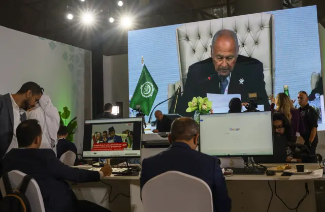 Journalists watch a speech by Arab League Secretary-General Ahmed Aboul Gheit on a screen at the media centre during the opening of the emergency Arab-Islamic summit to discuss the Israeli attack on Qatar in Doha, Qatar, 15 September 2025.
