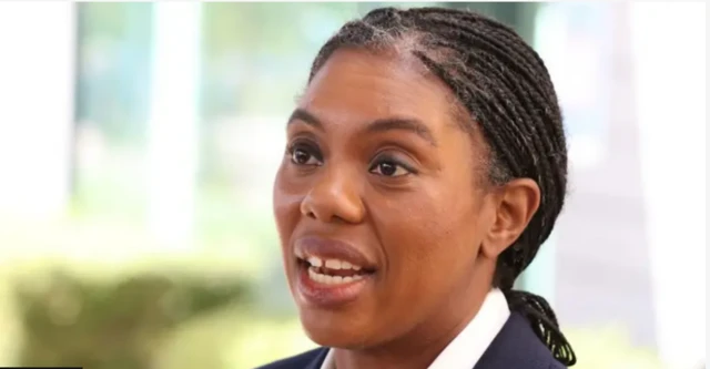 صورة لزعيمة حزب المحافظين، كيمي بادينوخ، ترتدي سترة سوداء وقميصاً أبيض