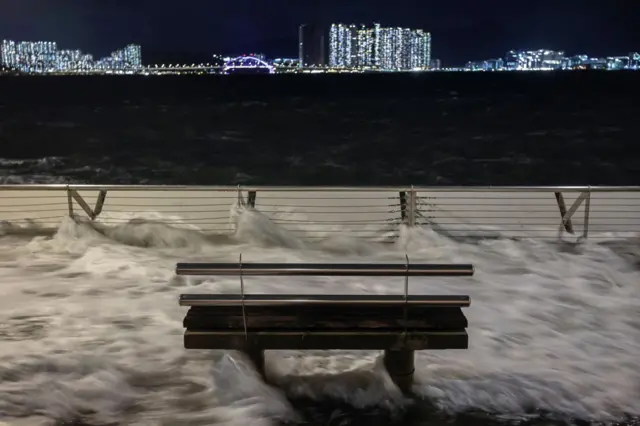 Waves from Super Typhoon Ragasa crash onto chair by the shore in Hong Kong, China, September 23, 2025.